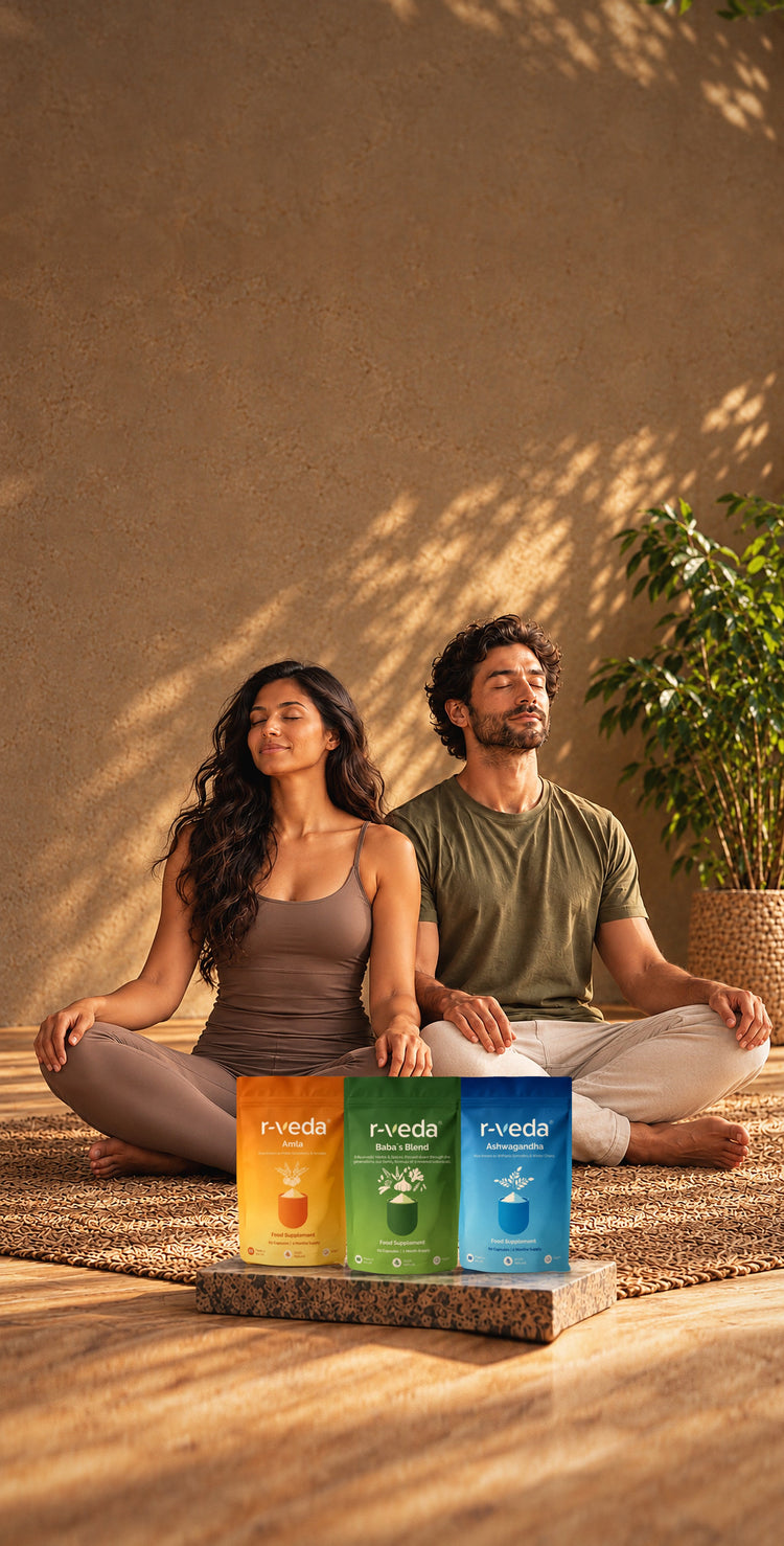 Two people meditating beside r-veda Amla, Baba's Blend and Ashwagandha pouches